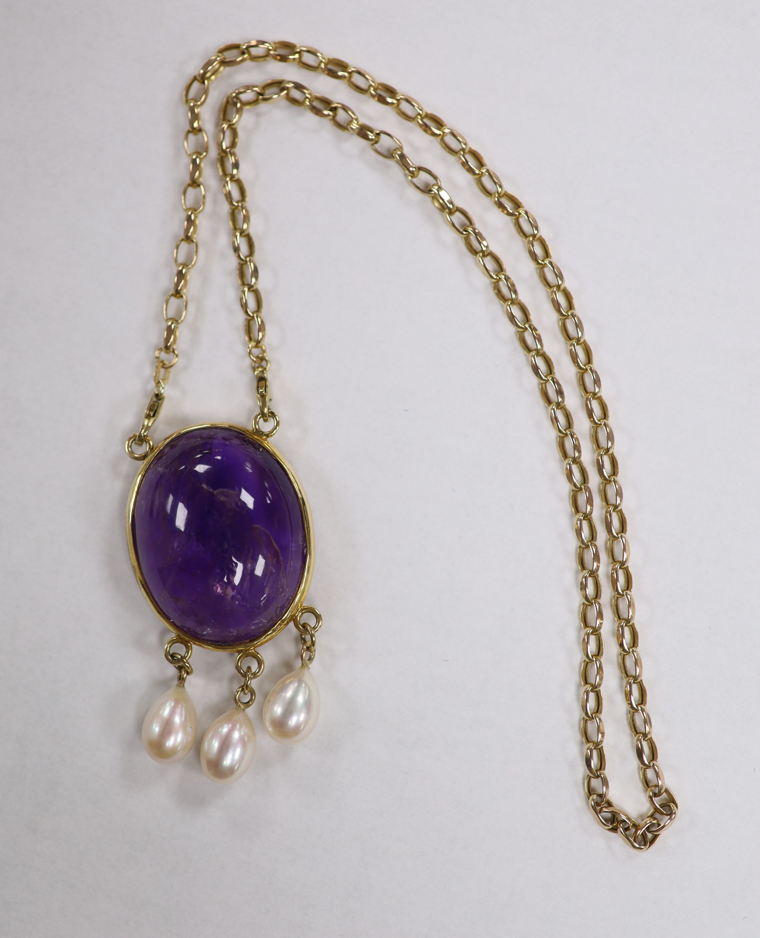 A modern yellow metal mounted, oval amethyst pebble and three stone cultured pearl set drop pendant, 66mm, on a 9ct gold chain